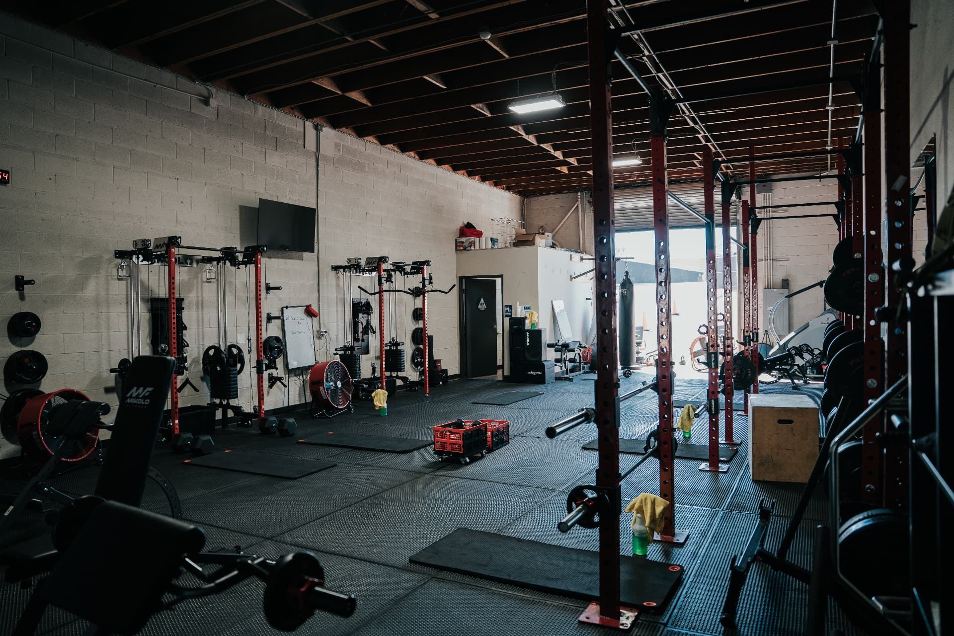 LionStrong Athletics turf area with sleds and open garage door