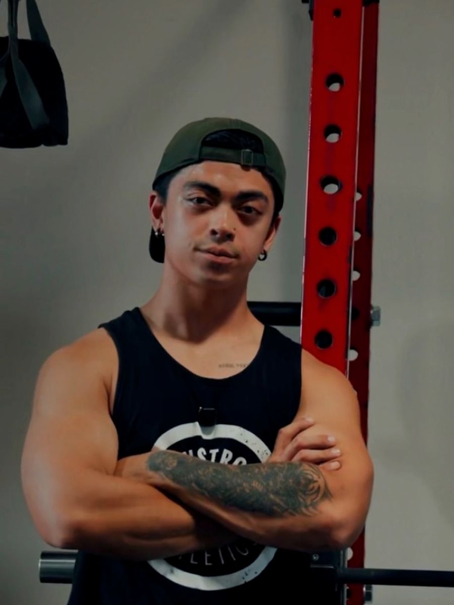 Justice Martin, group personal training head trainer at LionStrong Athletics, arms crossed in the gym